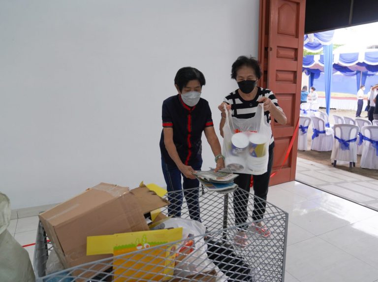 Oma Huang Cen Yek (kiri) membawa karton bekas untuk disumbangkan ke Depo.