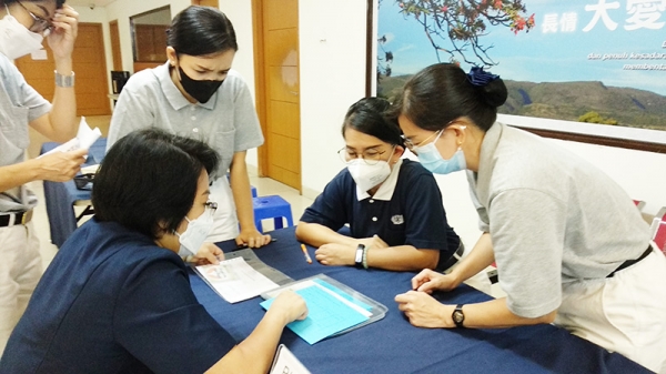 Ng Jan Njoek (kiri) selaku Koordinator Misi Amal Komunitas He Qi Utara 2 memberi pengarahan kepada para relawan mengenai tata cara penyerahan bantuan Tzu Chi.